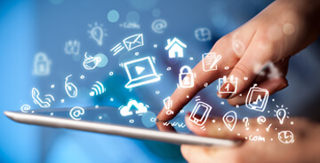 Stock image showing computer icons hovering over a tablet